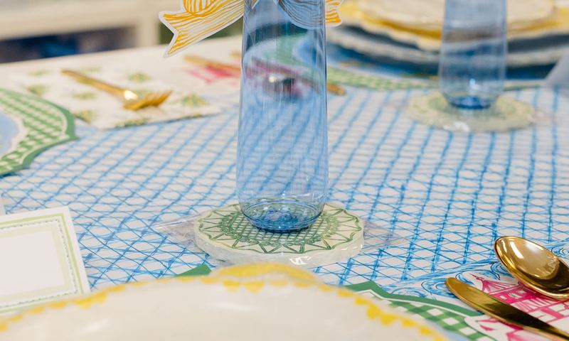 Scalloped yellow and cream plate with a blue glass and gold bow